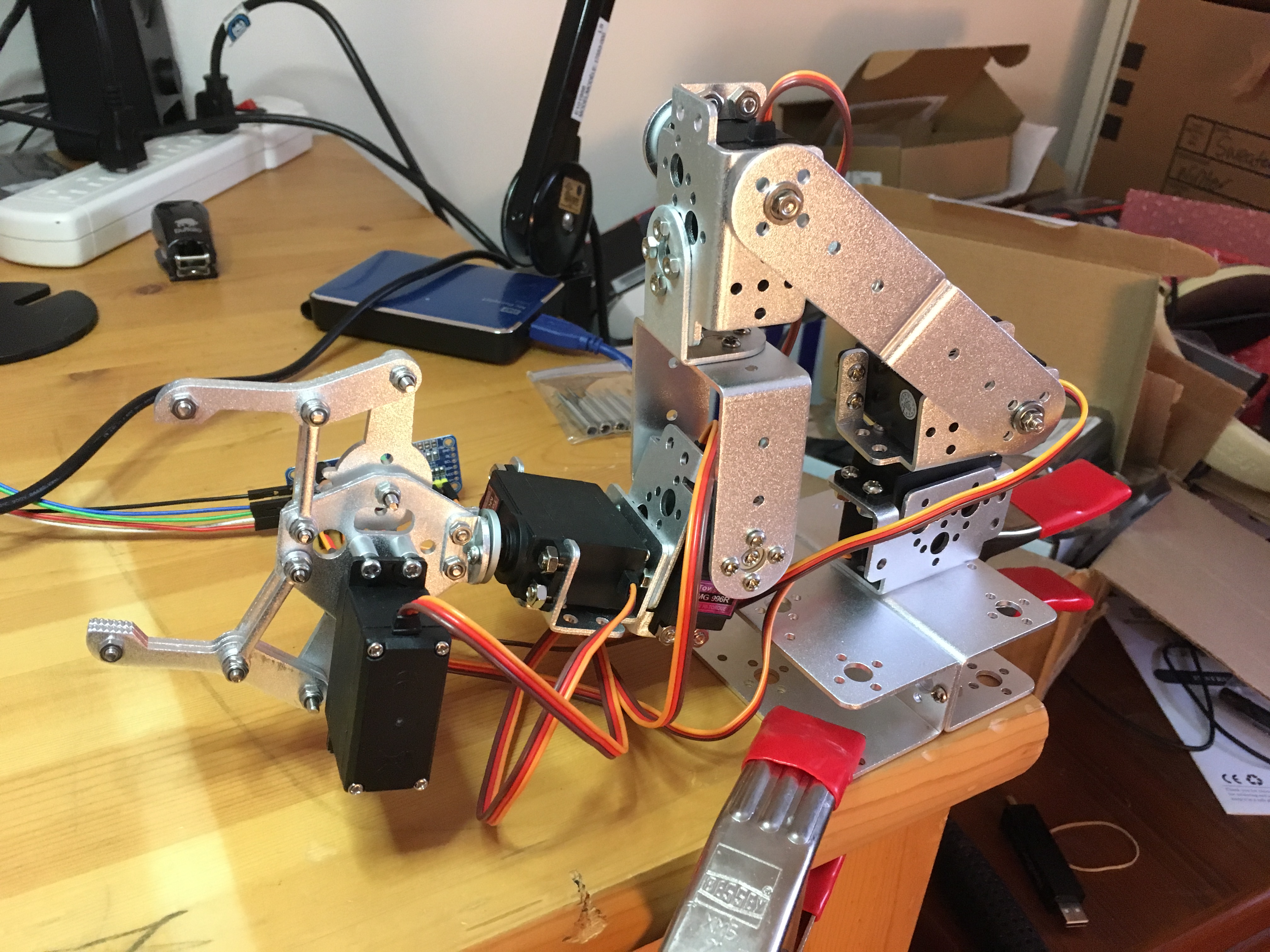 photo of robot with disorganized office in background